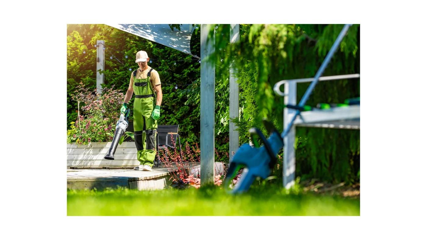 Garden worker clearing leaves from a residential yard