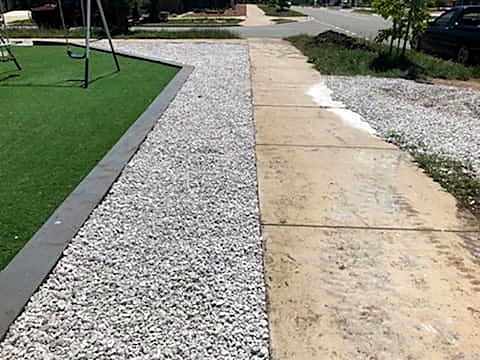 Neatly edged garden bed beside a concrete path after a tidy-up